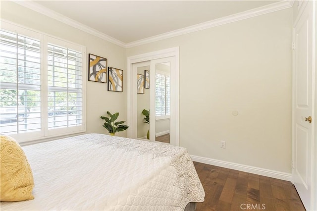 bedroom with dark wood-style floors, ornamental molding, and baseboards