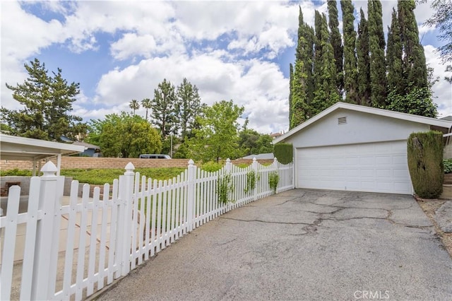 detached garage featuring fence
