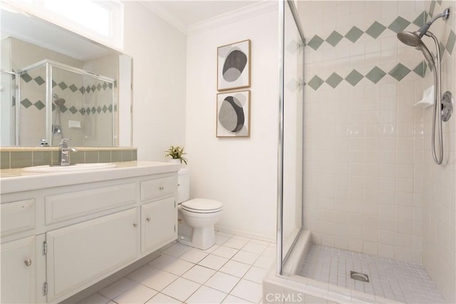 bathroom with a shower stall, crown molding, toilet, tile patterned floors, and vanity
