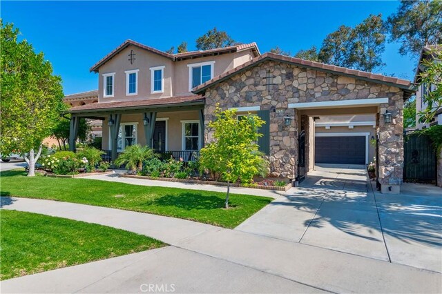 12538 Old Port Ct, Rancho Cucamonga, CA 91739 - view of front of house featuring concrete driveway, a front yard, stucco siding, a porch, and a garage
