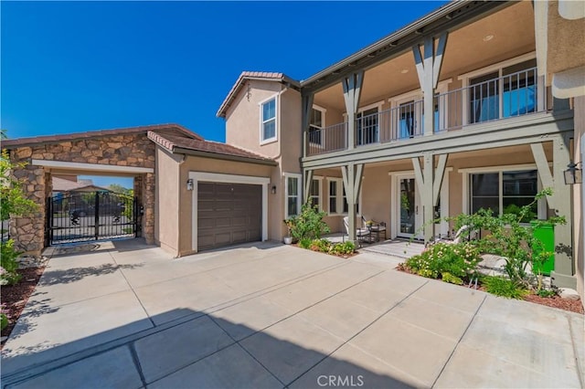 12538 Old Port Ct, Rancho Cucamonga, CA 91739 - view of property featuring stucco siding, concrete driveway, a garage, a gate, and stone siding
