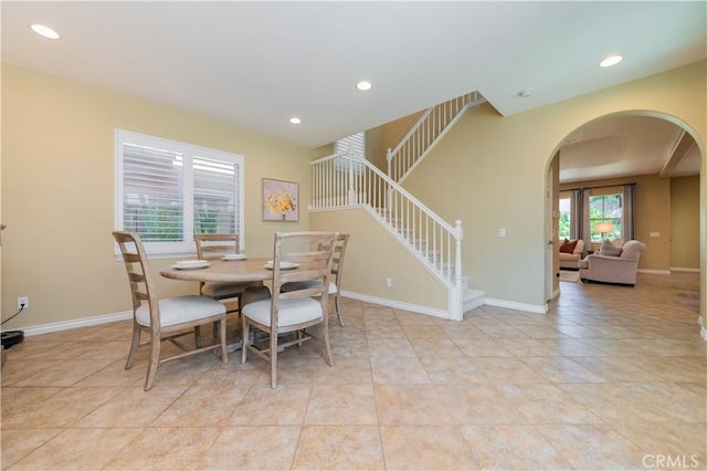 12538 Old Port Ct, Rancho Cucamonga, CA 91739 - tiled dining area with arched walkways, stairway, recessed lighting, and baseboards