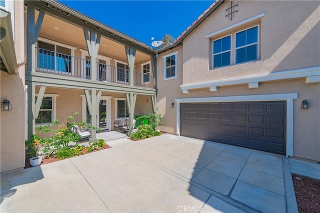 12538 Old Port Ct, Rancho Cucamonga, CA 91739 - back of house with stucco siding, an attached garage, and concrete driveway