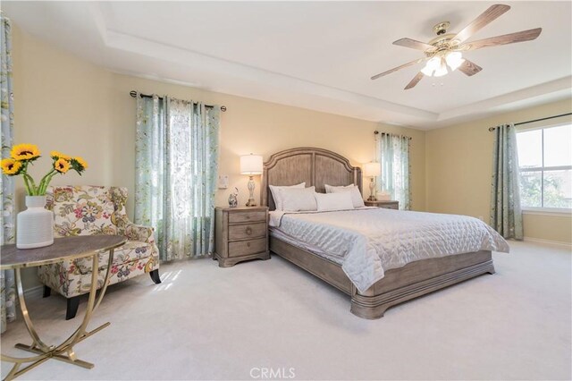 12538 Old Port Ct, Rancho Cucamonga, CA 91739 - bedroom featuring a raised ceiling, light carpet, and a ceiling fan