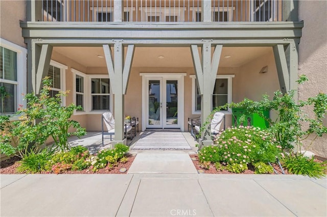 12538 Old Port Ct, Rancho Cucamonga, CA 91739 - view of exterior entry featuring french doors, stucco siding, and a balcony