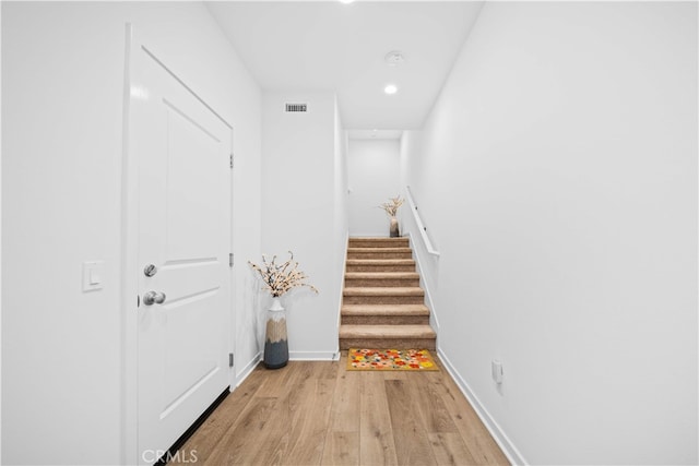 entryway with light wood-style floors, stairs, recessed lighting, and baseboards