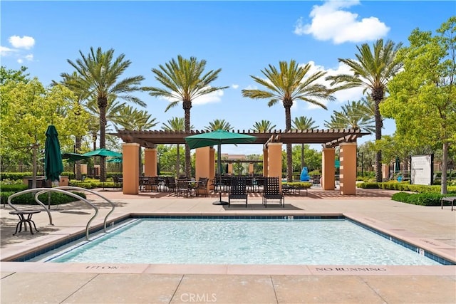 community pool with a pergola and a patio area