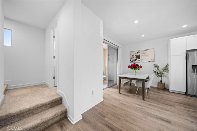 interior space featuring recessed lighting, stairway, light wood-type flooring, and baseboards