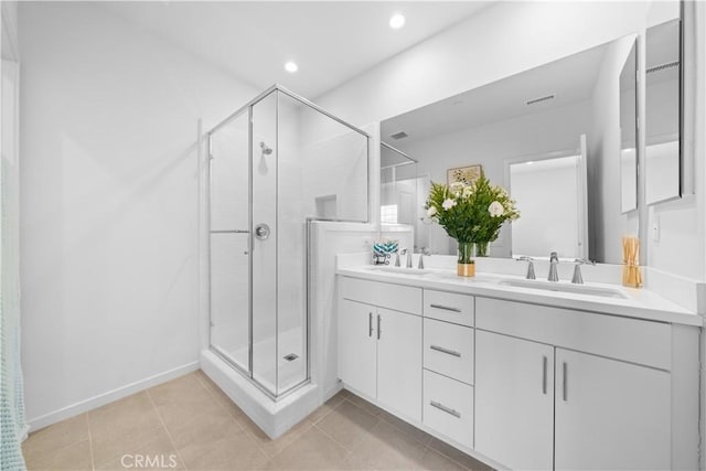 full bathroom with a stall shower, double vanity, tile patterned flooring, and recessed lighting
