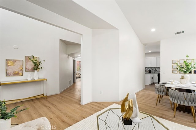 3116 Windhaven Way, Corona, CA 92882 - living area featuring light wood-type flooring, arched walkways, recessed lighting, and baseboards