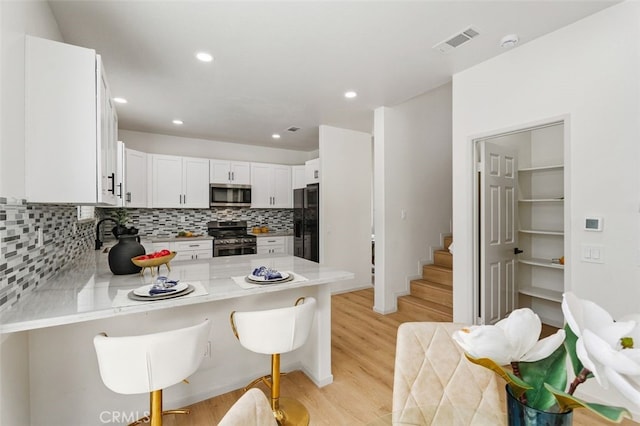 3116 Windhaven Way, Corona, CA 92882 - kitchen featuring stainless steel appliances, backsplash, a peninsula, light wood-style flooring, and light countertops