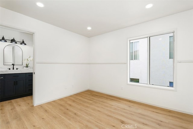 3116 Windhaven Way, Corona, CA 92882 - spare room featuring light wood-type flooring, a sink, recessed lighting, and baseboards