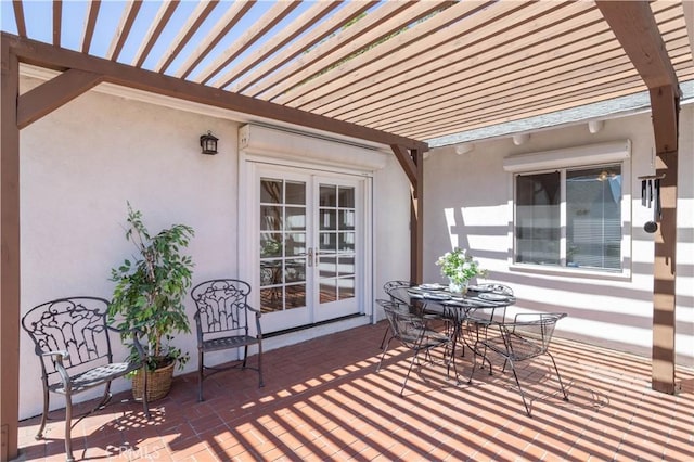 view of patio / terrace with french doors, a pergola, and outdoor dining space