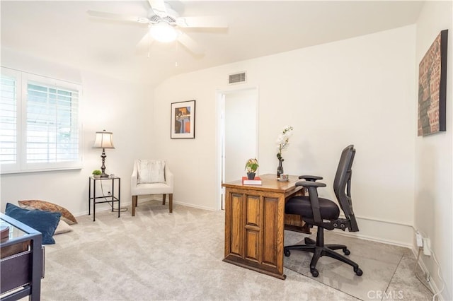 office space with light colored carpet, ceiling fan, and baseboards