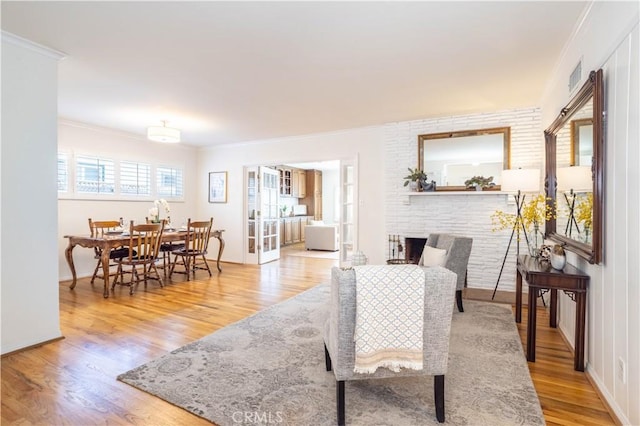 living room with ornamental molding, wood finished floors, and baseboards