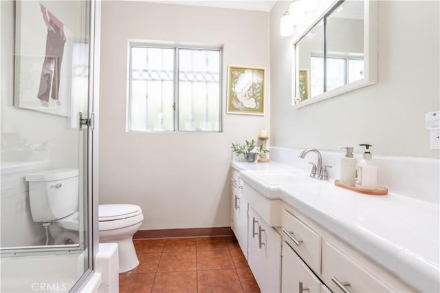 full bath with toilet, healthy amount of natural light, vanity, and tile patterned flooring