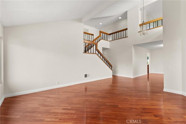 unfurnished living room with wood finished floors, stairs, baseboards, recessed lighting, and high vaulted ceiling