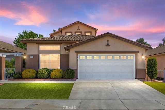 588 Twin Hills Dr, Banning, CA 92220 - mediterranean / spanish home with driveway, stucco siding, an attached garage, a tiled roof, and a front lawn