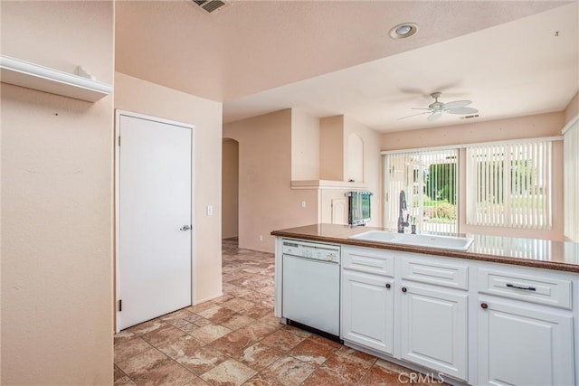 588 Twin Hills Dr, Banning, CA 92220 - kitchen with dishwasher, a sink, arched walkways, a ceiling fan, and white cabinetry