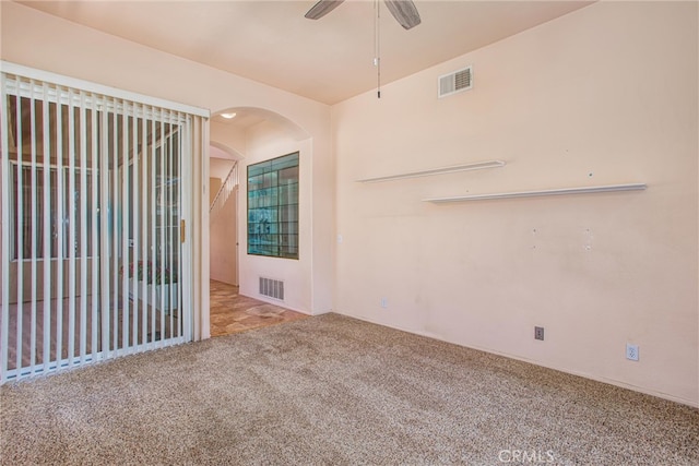 588 Twin Hills Dr, Banning, CA 92220 - unfurnished room featuring carpet, arched walkways, and ceiling fan