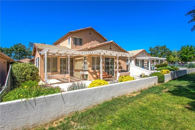 588 Twin Hills Dr, Banning, CA 92220 - rear view of property featuring a pergola, stucco siding, a tiled roof, a lawn, and a patio
