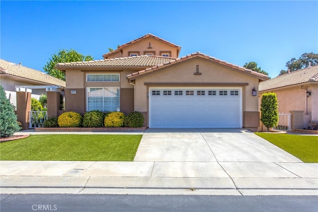588 Twin Hills Dr, Banning, CA 92220 - mediterranean / spanish-style house with stucco siding, an attached garage, concrete driveway, a tiled roof, and a front lawn