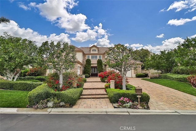 6791 Trevino Dr, Moorpark, CA 93021 - view of front of home featuring stone siding and decorative driveway