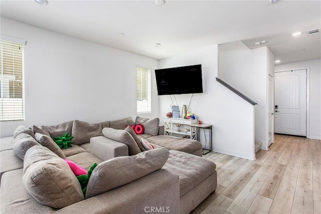 2335 Powell Dr, Rialto, CA 92377 - living room with light wood-style floors, recessed lighting, baseboards, and stairway
