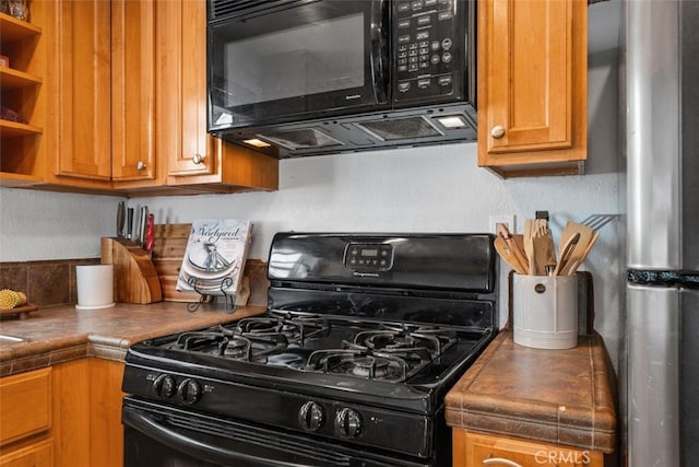 1100 Euclid Ave Unit 108, Long Beach, CA 90804 - kitchen with black appliances, open shelves, and brown cabinetry