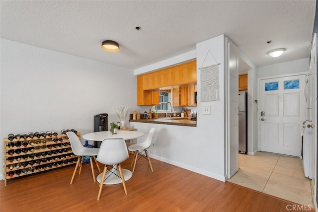 1100 Euclid Ave Unit 108, Long Beach, CA 90804 - dining area with a textured ceiling, light wood-style flooring, and baseboards