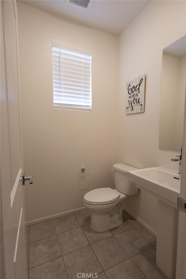 1810 Park Place Ln, Riverside, CA 92501 - bathroom featuring toilet, baseboards, and tile patterned floors