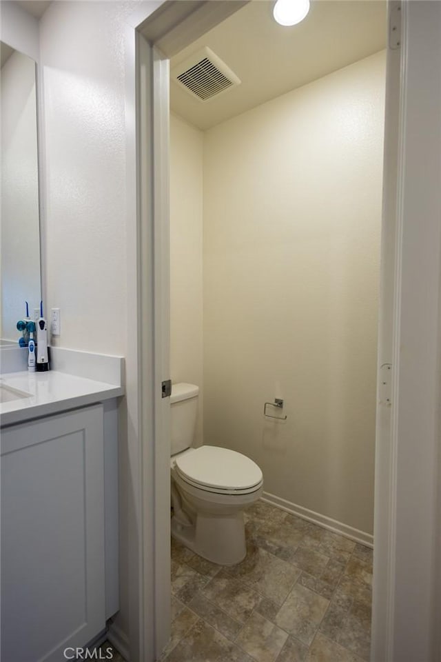 1810 Park Place Ln, Riverside, CA 92501 - bathroom with stone finish floors, toilet, and vanity