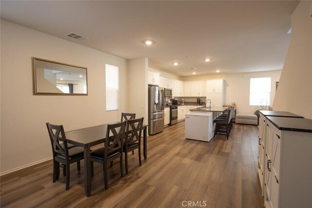 1810 Park Place Ln, Riverside, CA 92501 - dining area with recessed lighting, dark wood-style flooring, and baseboards