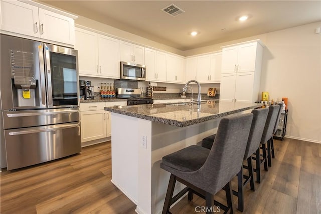 1810 Park Place Ln, Riverside, CA 92501 - kitchen with stainless steel appliances, a sink, white cabinetry, and recessed lighting