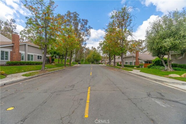6523 E Camino Unit 2, Anaheim, CA 92807 - view of asphalt road with sidewalks, curbs, and a residential view