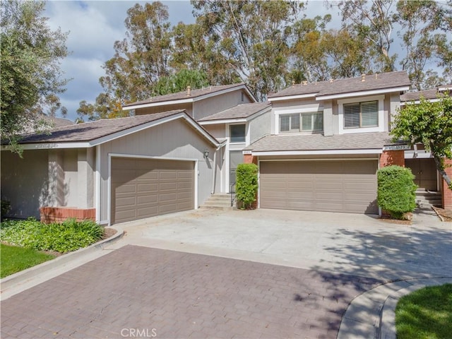 6523 E Camino Unit 2, Anaheim, CA 92807 - view of front of property featuring decorative driveway, stucco siding, and a shingled roof