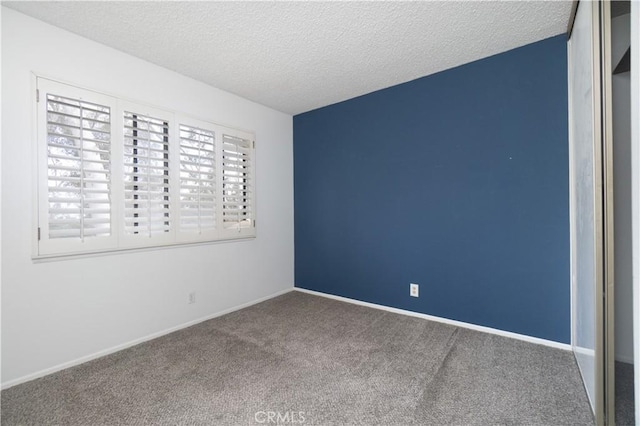 6523 E Camino Unit 2, Anaheim, CA 92807 - spare room with carpet floors, a textured ceiling, and baseboards