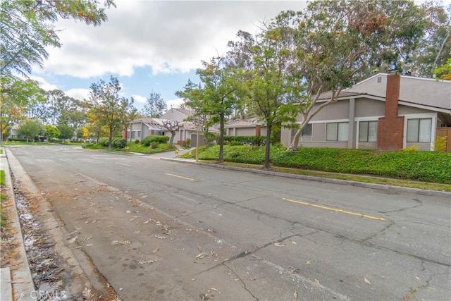6523 E Camino Unit 2, Anaheim, CA 92807 - view of asphalt road with curbs and a residential view