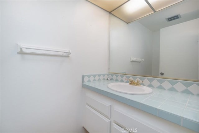 6523 E Camino Unit 2, Anaheim, CA 92807 - bathroom featuring vanity and backsplash
