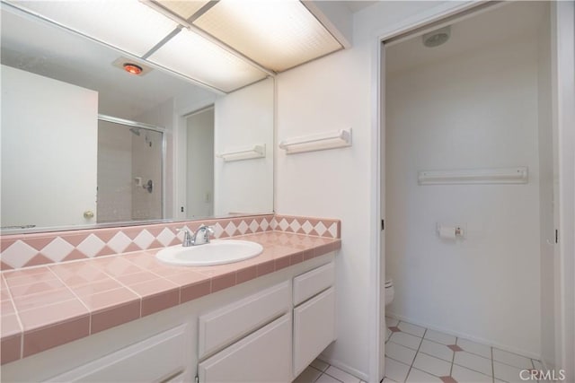 6523 E Camino Unit 2, Anaheim, CA 92807 - full bathroom featuring a shower stall, toilet, tile patterned floors, tasteful backsplash, and vanity