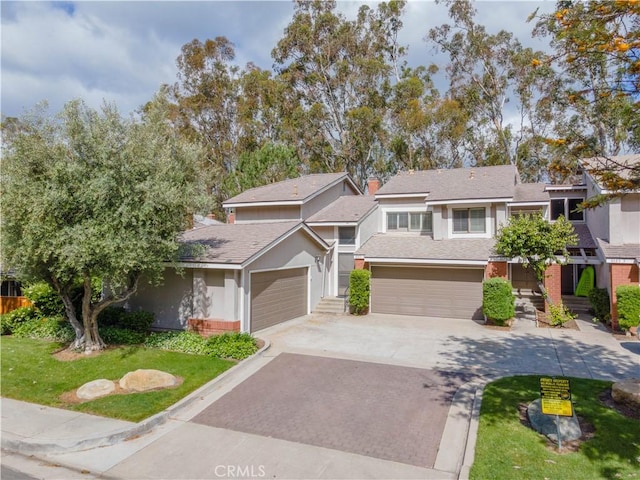 6523 E Camino Unit 2, Anaheim, CA 92807 - view of front of property featuring decorative driveway, roof with shingles, a front lawn, and stucco siding