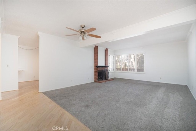 6523 E Camino Unit 2, Anaheim, CA 92807 - unfurnished living room with ceiling fan, a brick fireplace, wood finished floors, and beamed ceiling