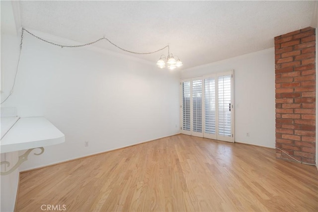 6523 E Camino Unit 2, Anaheim, CA 92807 - unfurnished room featuring light wood-style flooring, crown molding, a chandelier, and a textured ceiling