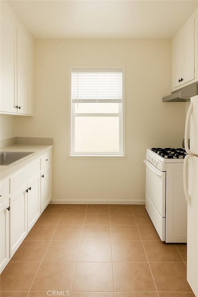 267 La Verne Ave, Long Beach, CA 90803 - laundry room featuring a sink, light tile patterned floors, and baseboards