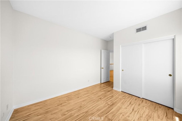 18560 Stonegate Ln, Rowland Heights, CA 91748 - unfurnished bedroom featuring light wood-style floors, a closet, and baseboards
