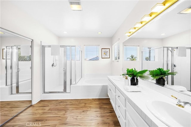 18560 Stonegate Ln, Rowland Heights, CA 91748 - bathroom with a stall shower, double vanity, a bath, wood finished floors, and recessed lighting