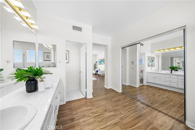 18560 Stonegate Ln, Rowland Heights, CA 91748 - full bath featuring double vanity, wood finished floors, and baseboards
