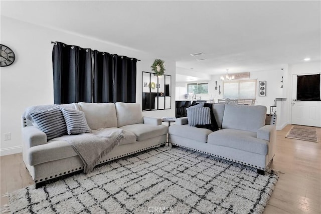 21046 Lone Eagle Rd, Apple Valley, CA 92308 - living room with a chandelier, light wood finished floors, baseboards, and recessed lighting