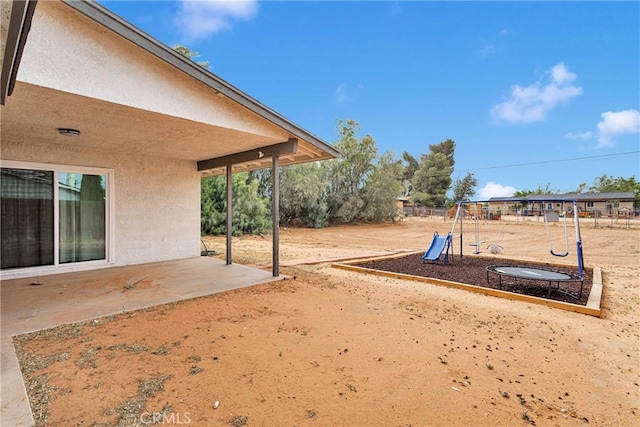 21046 Lone Eagle Rd, Apple Valley, CA 92308 - view of yard with a playground, a patio area, and fence