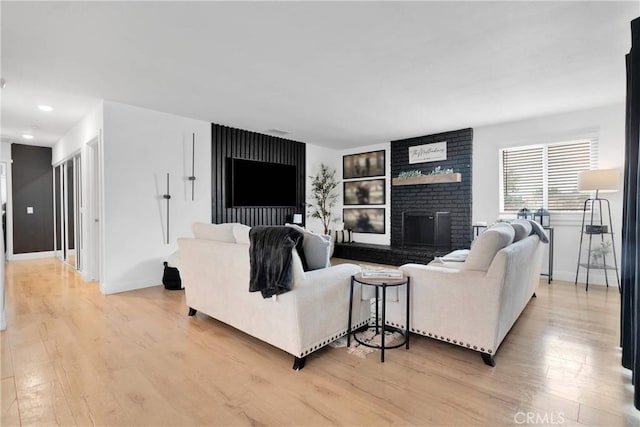 21046 Lone Eagle Rd, Apple Valley, CA 92308 - living area featuring light wood-style flooring, a fireplace, and baseboards
